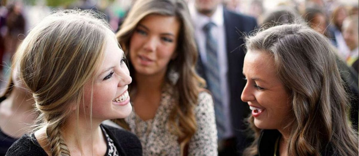 Two women talking together at General Conference of The Church of Jesus Christ of Latter-day Saints.